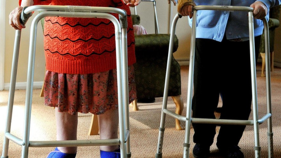 Two elderly women with zimmer frame