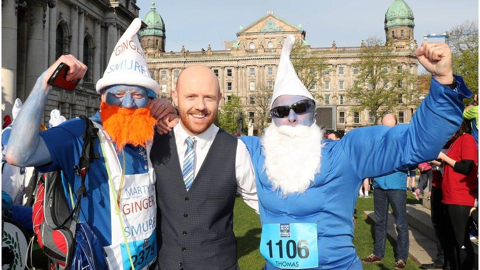 BBC NI's Barra Best with runners dressed as smurfs outside Belfast City Hall, Belfast City Marathon, 1 May 2017