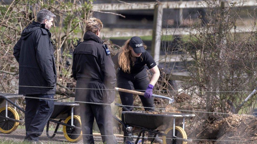 police dig grounds at a farm