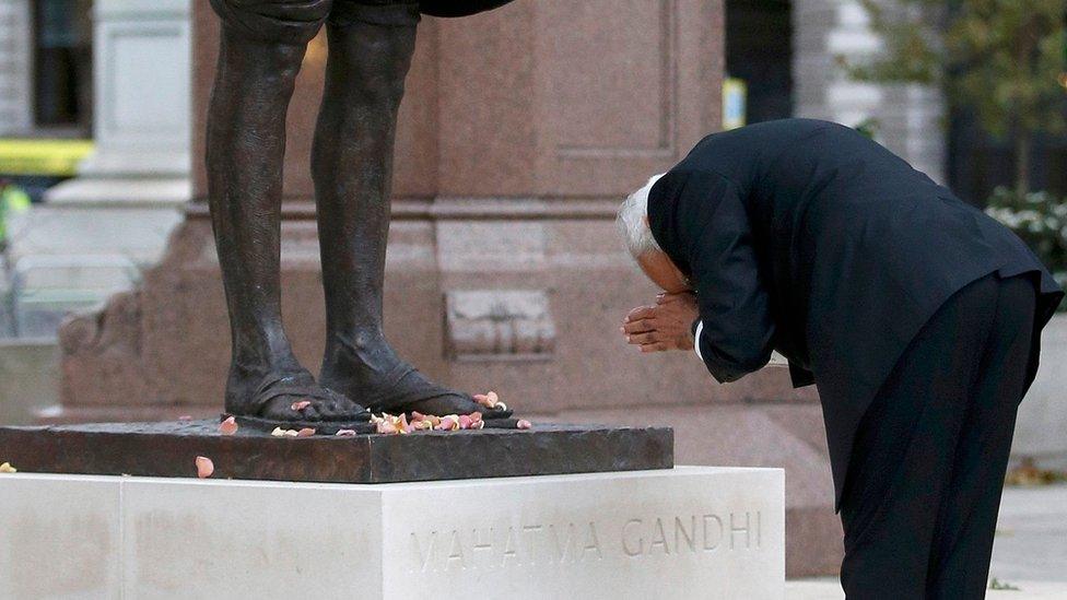 Mr Modi bows at the statue of Mahatma Gandhi in Parliament Square