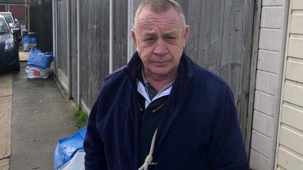 Man standing on pavement in Essex