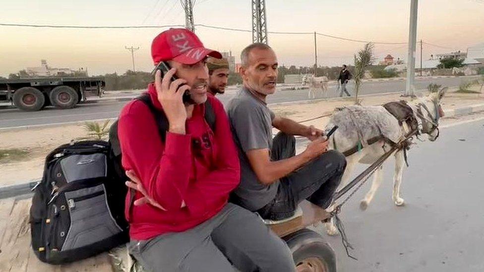 Ahmed Sabra (L) and Abdalrahman Alharazin (R), British citizens who were prevented from leaving Gaza via Egypt, sit on a donkey cart near the Rafah border crossing (8 November 2023)