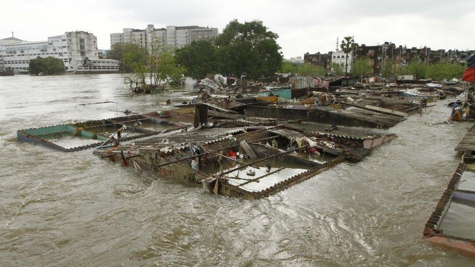 Houses are submerged in flood waters in Chennai, India, Thursday, Dec. 3, 2015.