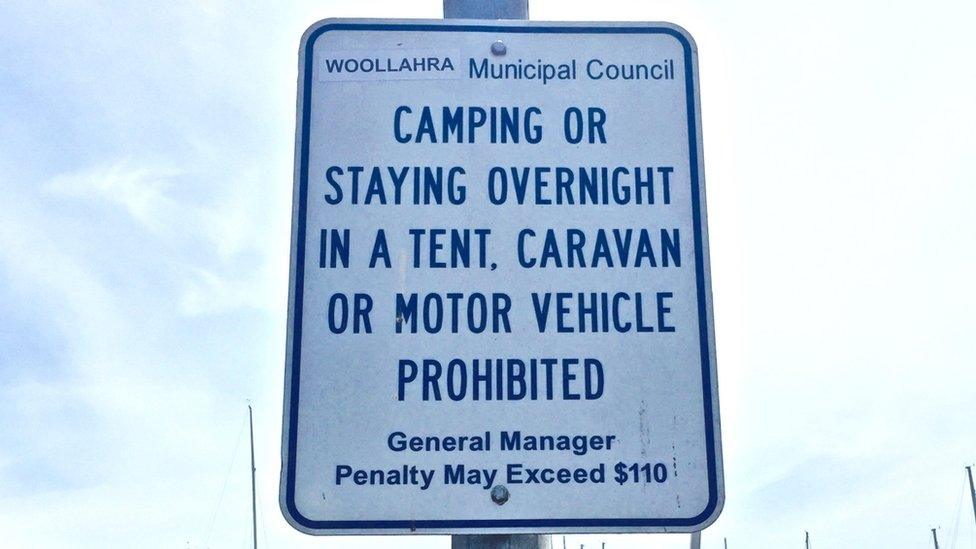 A sign at a Sydney beach warns it is prohibited to stay there overnight