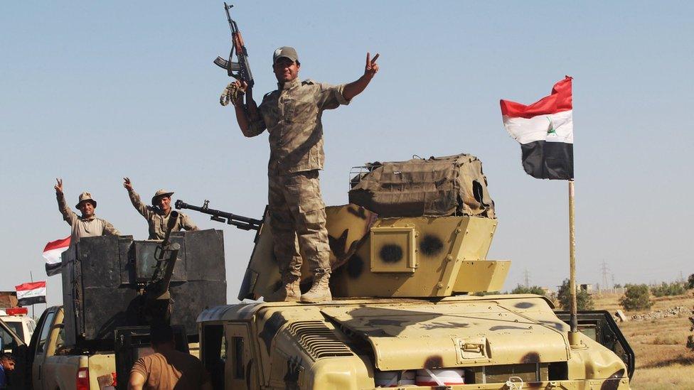 Iraqi security forces members gesture near Falluja, Iraq, May 30, 2016