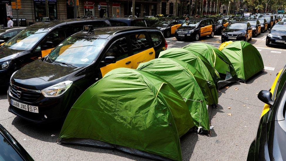 6 Hundreds of parked taxi vehicles occupy the Gran Via avenue in downtown Barcelona, north-eastern Spain, 29 July 2018, during their fifth day of strike