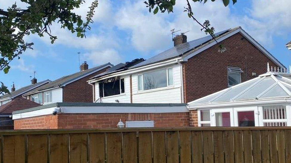 Rear of the house showing damaged roof