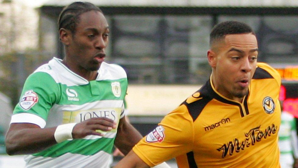 Jazzi Barnum Bobb of Newport County beats Nathan Smith of Yeovil Town to the ball