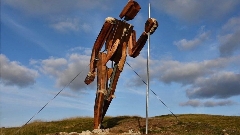 Statue standing among the rural landscape