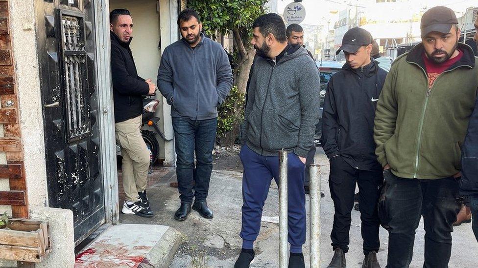 Palestinians gather outside the house of 57-year-old teacher Jawad Bouaqneh in Jenin, in the occupied West Bank (19 January 2023)