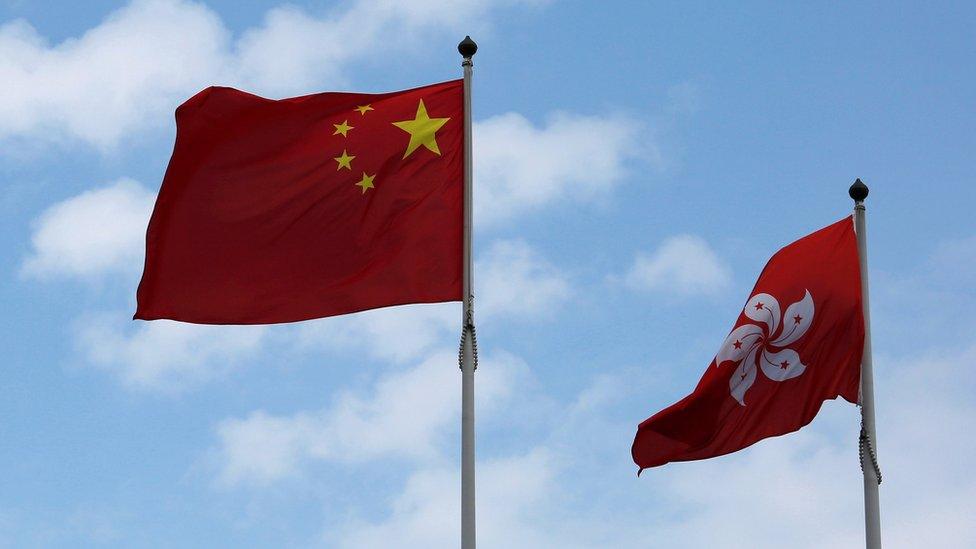 A Chinese national flag and a Hong Kong flag fly outside the Legislative Council in Hong Kong