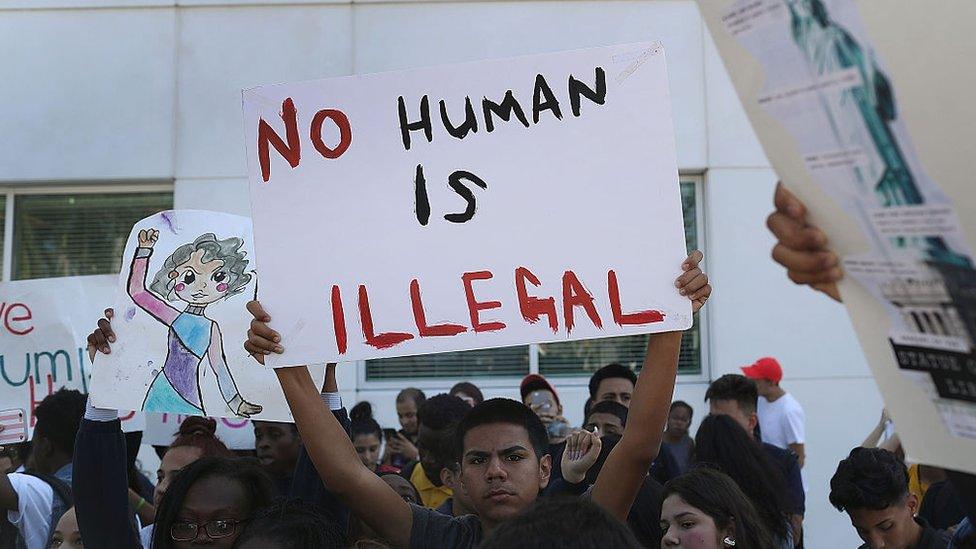 No Human is Illegal, a protesters sign reads