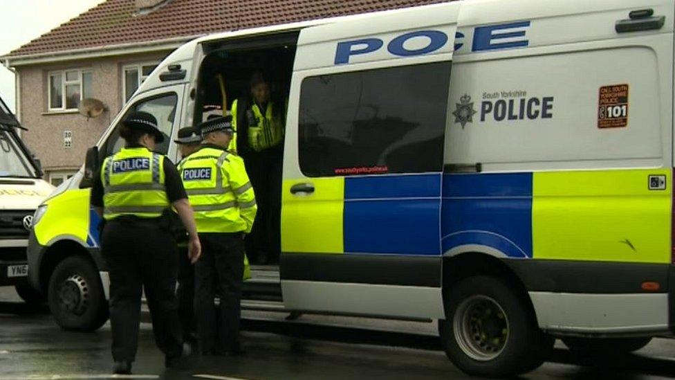 Police officers getting out of police van