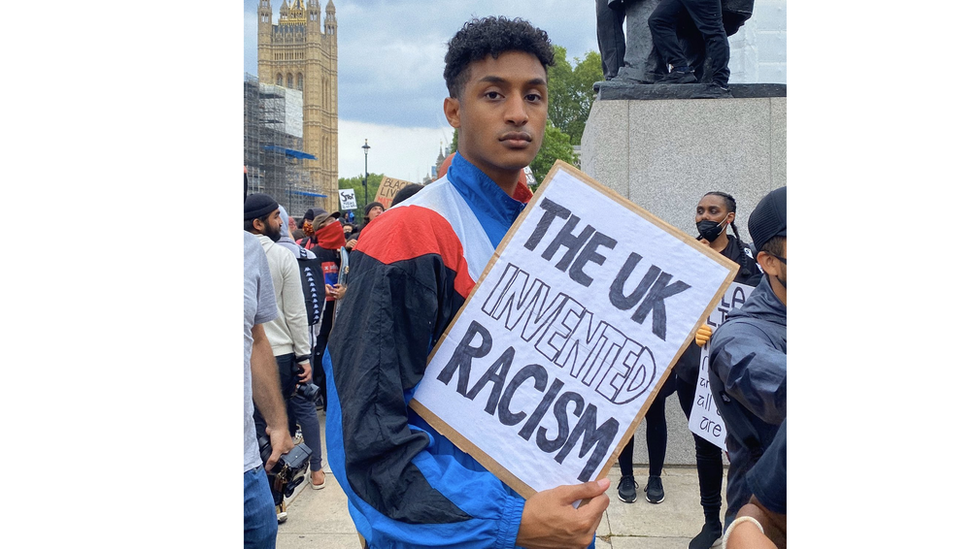 Man at Black Lives Matter protest holding sign