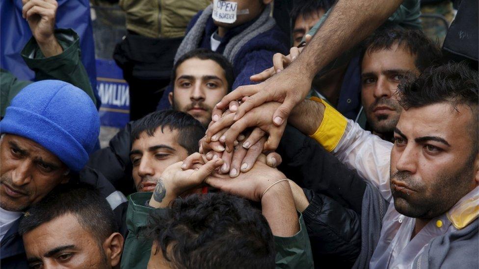 Iranian migrants sit on rail tracks during a hunger strike at the Greek-Macedonian border