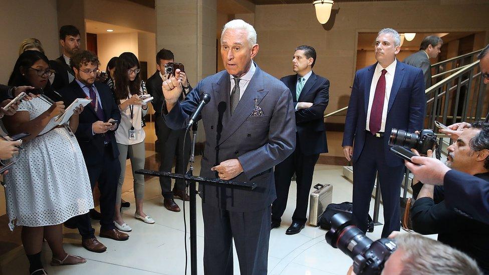 Roger Stone talks to the press after testifying before Congress.