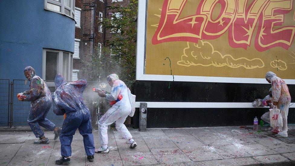 Paint-covered revellers take part in the traditional "Jouvert" opening parade of the Notting Hill carnival