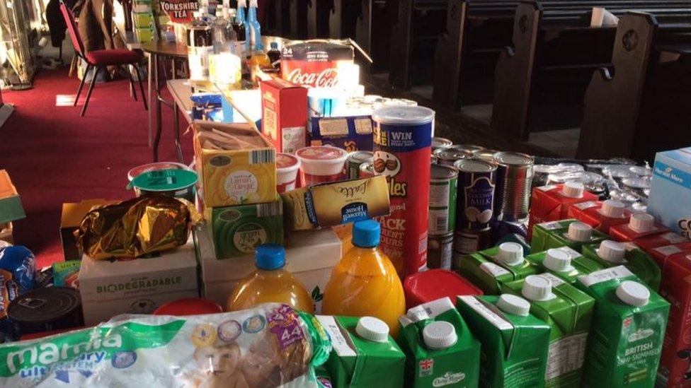 Items on tables at a foodbank inside a church