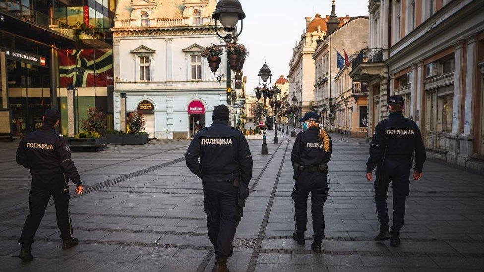 Serbian police have been out in Belgrade enforcing a curfew