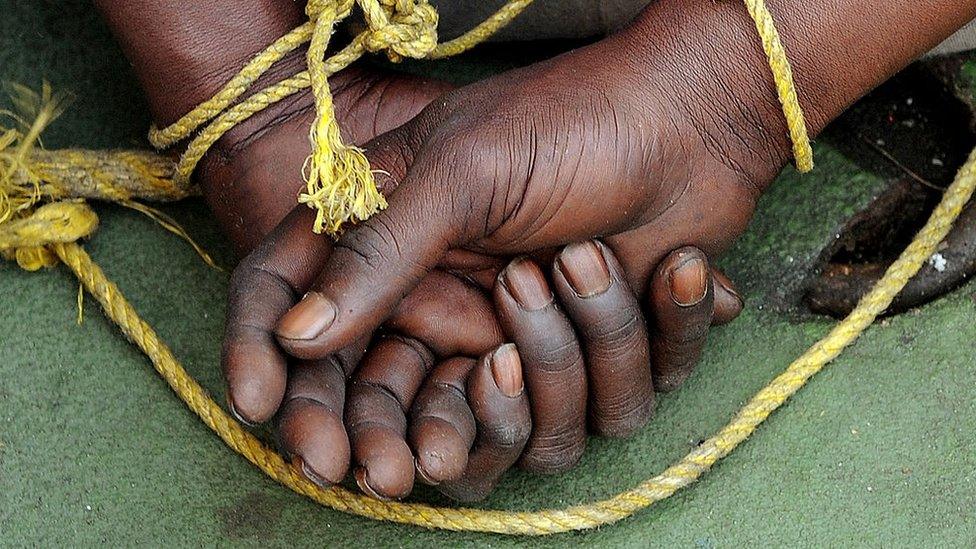 A suspected Somali pirate's hands are tied behind his back during a media interaction on board an Indian Coast guard ship off the coast of Mumbai on February 10, 2011