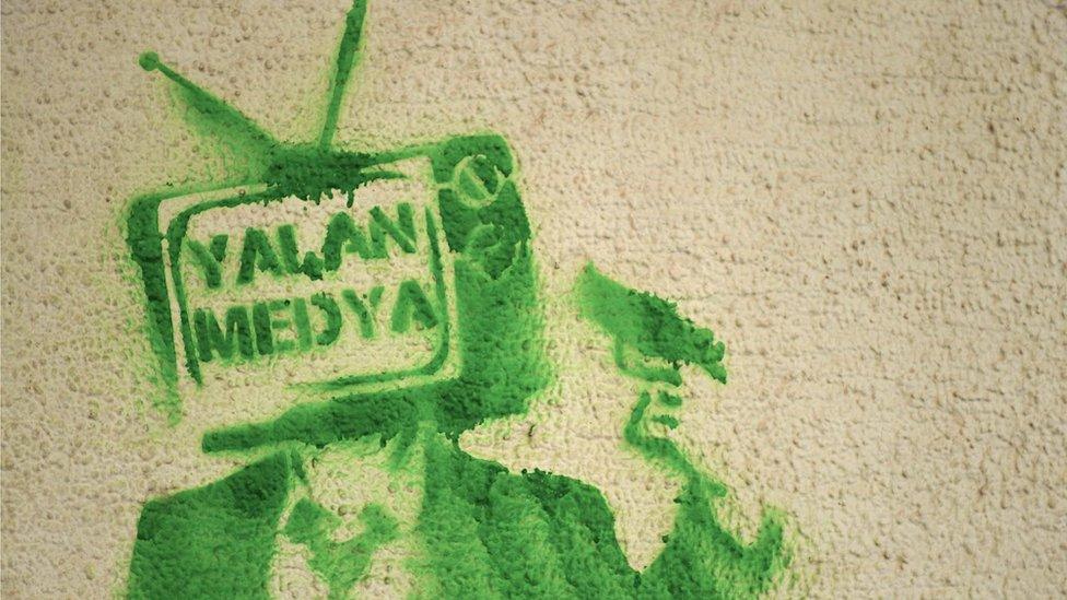 Graffiti seen on a wall at Gundogdu Square, Izmir, reads "Lying media"