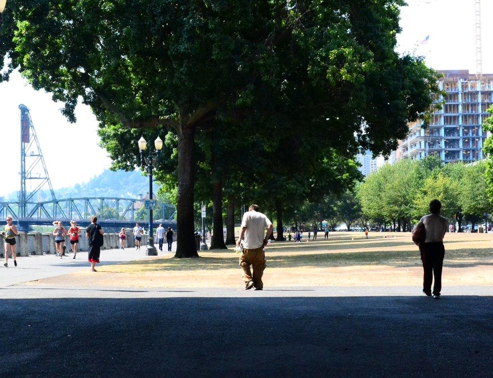 Homeless people walk on Portland's water front