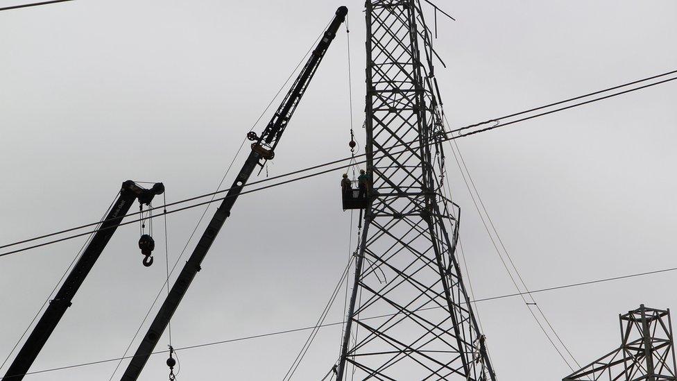 Workers repair the power grid