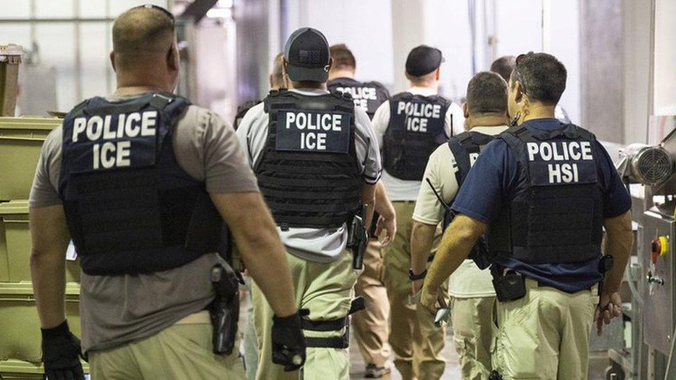 A ICE handout photo showing US immigration officers in a plant in Mississippi