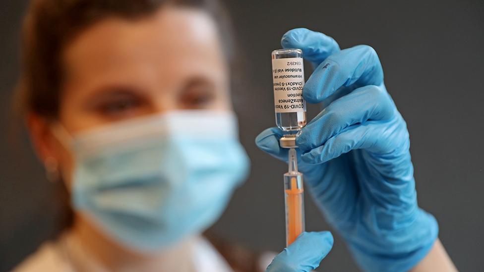 Clinical Pharmacist Ellie Morton prepares to administer the Oxford AstraZeneca COVID-19 Vaccine at the community vaccination centre at Kingston University's Penrhyn Road campus on March 12, 2021