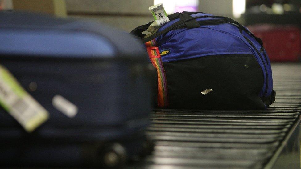 Luggage on a belt at Manchester Airport