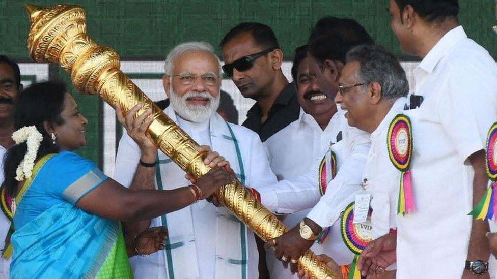 Members of Bharatiya Janata Party (BJP) give a golden scepter to Indian Prime Minister Narendra Modi (C) during a National Democratic Alliance (NDA) rally in Chennai on March 6, 2019.