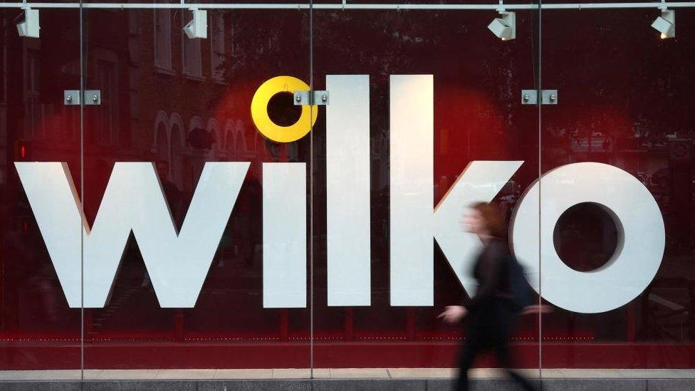 Woman walks past Wilko branch