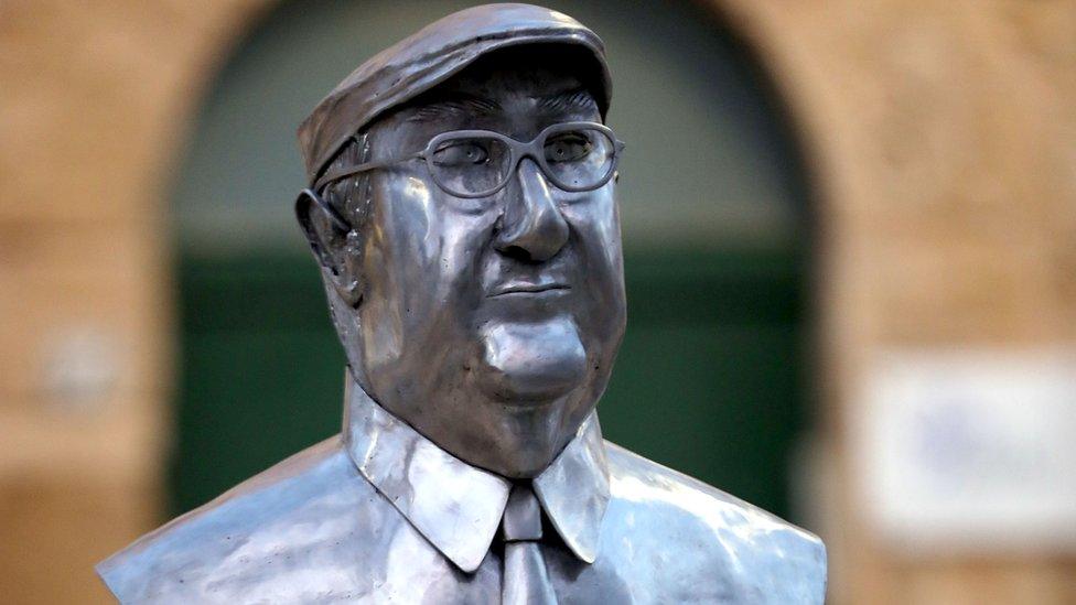 A sculpture of Sicilian writer Andrea Camilleri in front Montalbano's house in Punta Secca, Ragusa, Italy, 4 June 2018