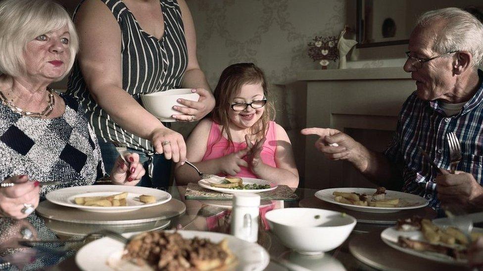 A young girl is served her dinner.