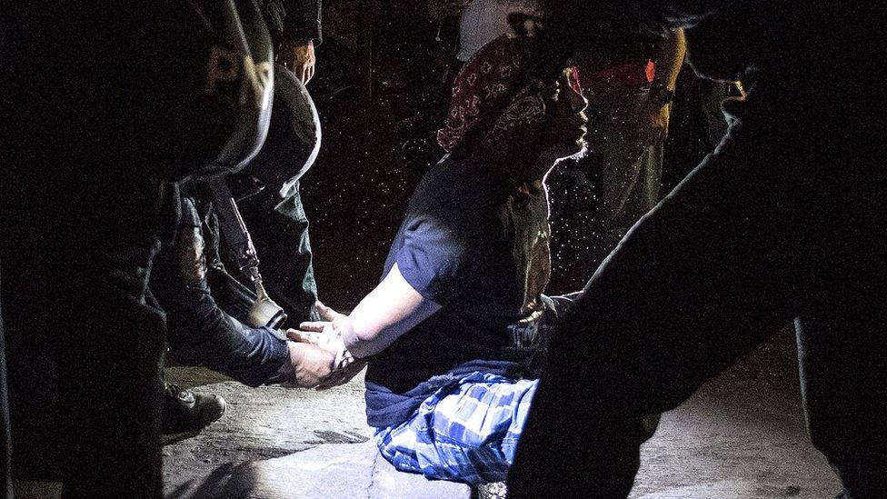 An alleged drug dealer is arrested during a raid in Maharlika Village, Taguig, south of Manila