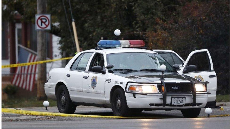 A Des Moines police department squad car with bullet holes seen on the passenger side door sits at the scene of a shooting, Wednesday, Nov. 2, 2016, in Des Moines, Iowa