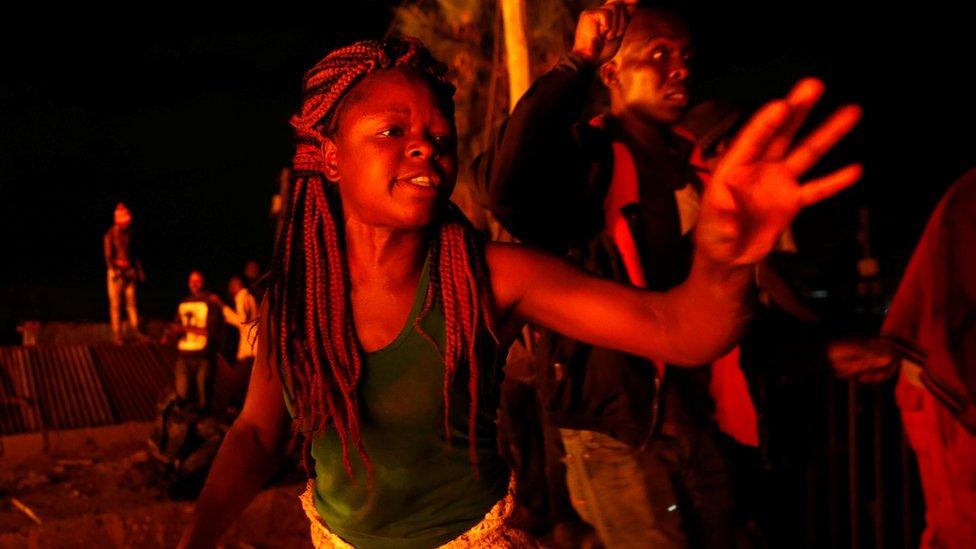 A woman reacts after escaping from the flames