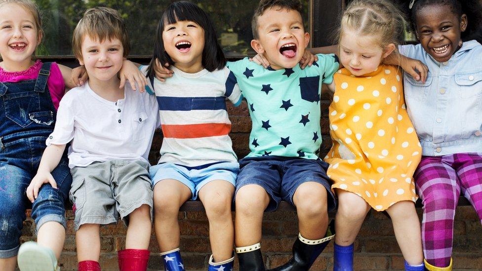 Kids-sitting-on-a-wall.