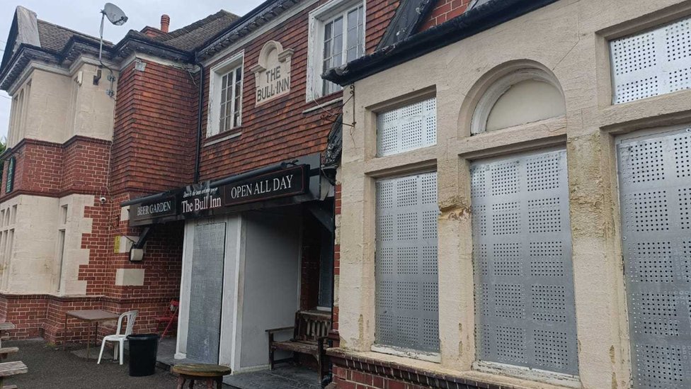 The Bull Inn with shutters on its windows and doors