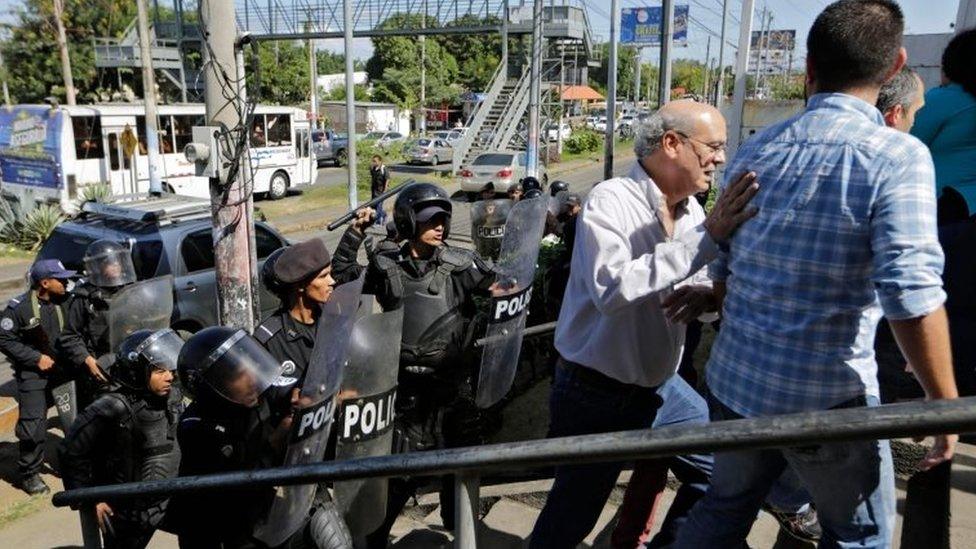 Riot police clear journalists from an area near a police station in Managua, Nicaragua. Photo: 15 December 2018