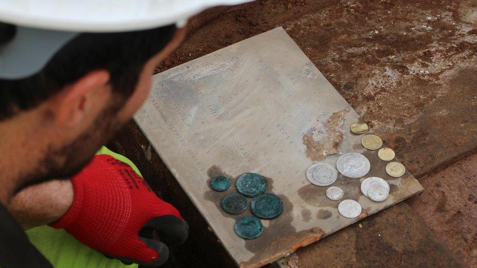 archaeologist with coins