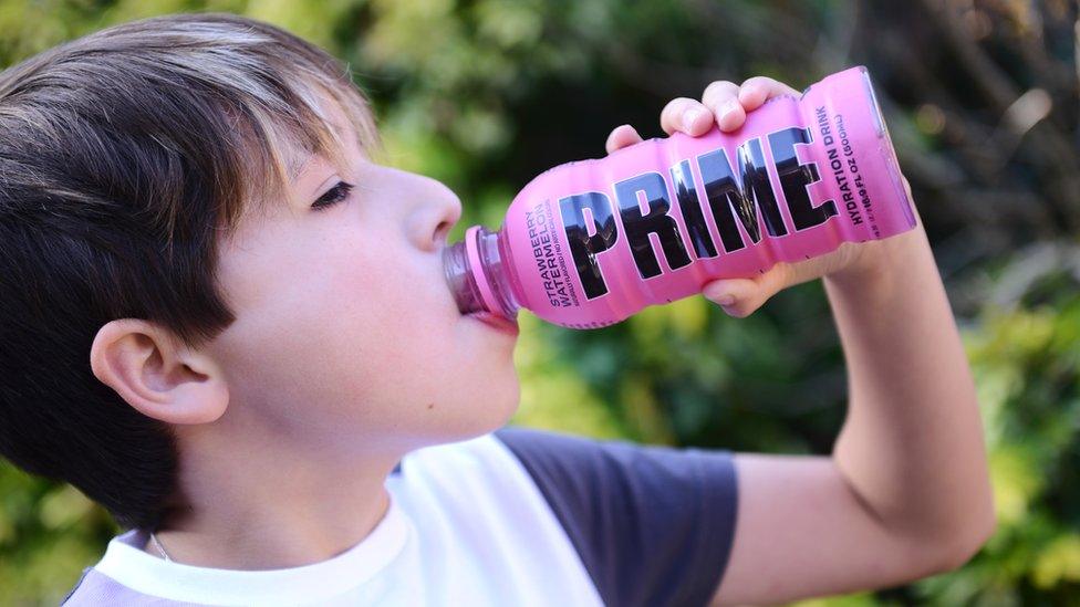 Young person drinking PRIME