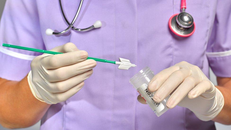 Nurse holding smear sample