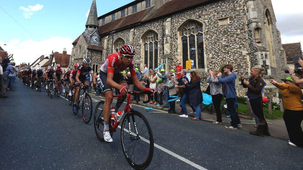 The Peloton passes Needham Market Parish Church during Stage Seven of the Tour of Britain