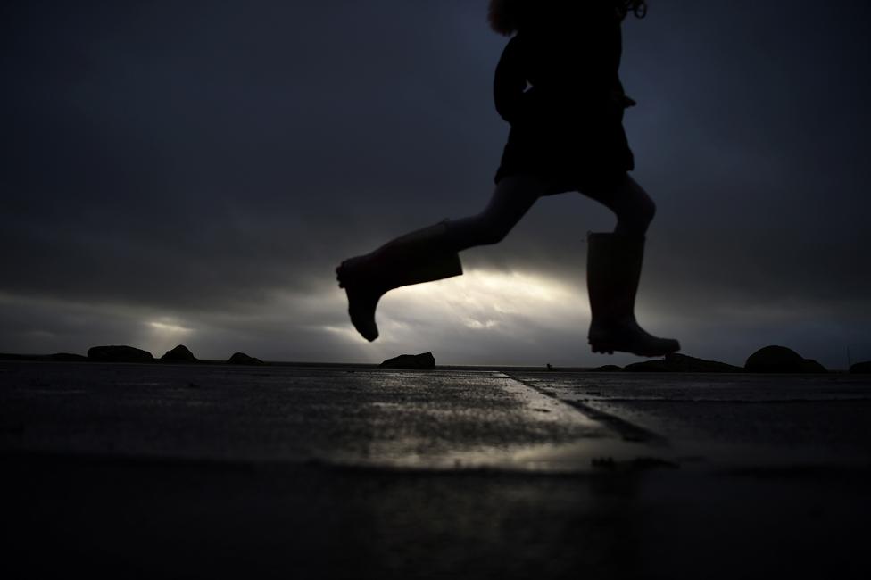 A girl runs in her Wellington boots as storm Barra makes landfall in Galway, Ireland, 7 December 2021.