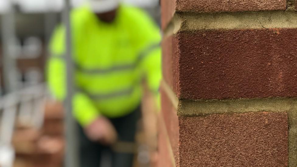 Blurred builder in hi-vis jacket