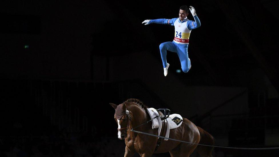 A man jumping on top of a horse