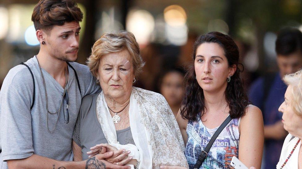 People on the Ramblas comfort each other following the attack