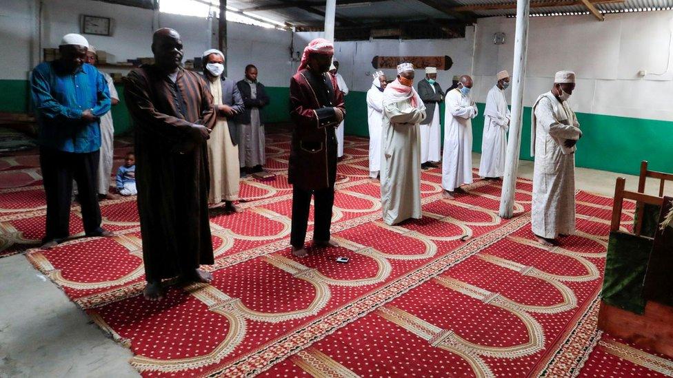 Muslim faithful observe social distancing as they perform Eid al-Fitr prayers, marking the end of the holy fasting month of Ramadan, inside a mosque closed amid concerns about the spread of the coronavirus disease (COVID-19), in Nairobi, Kenya, May 24, 2020.