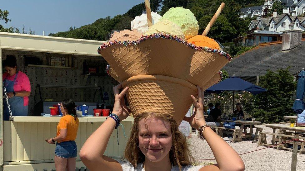 A woman wearing a hat called Sundae Best